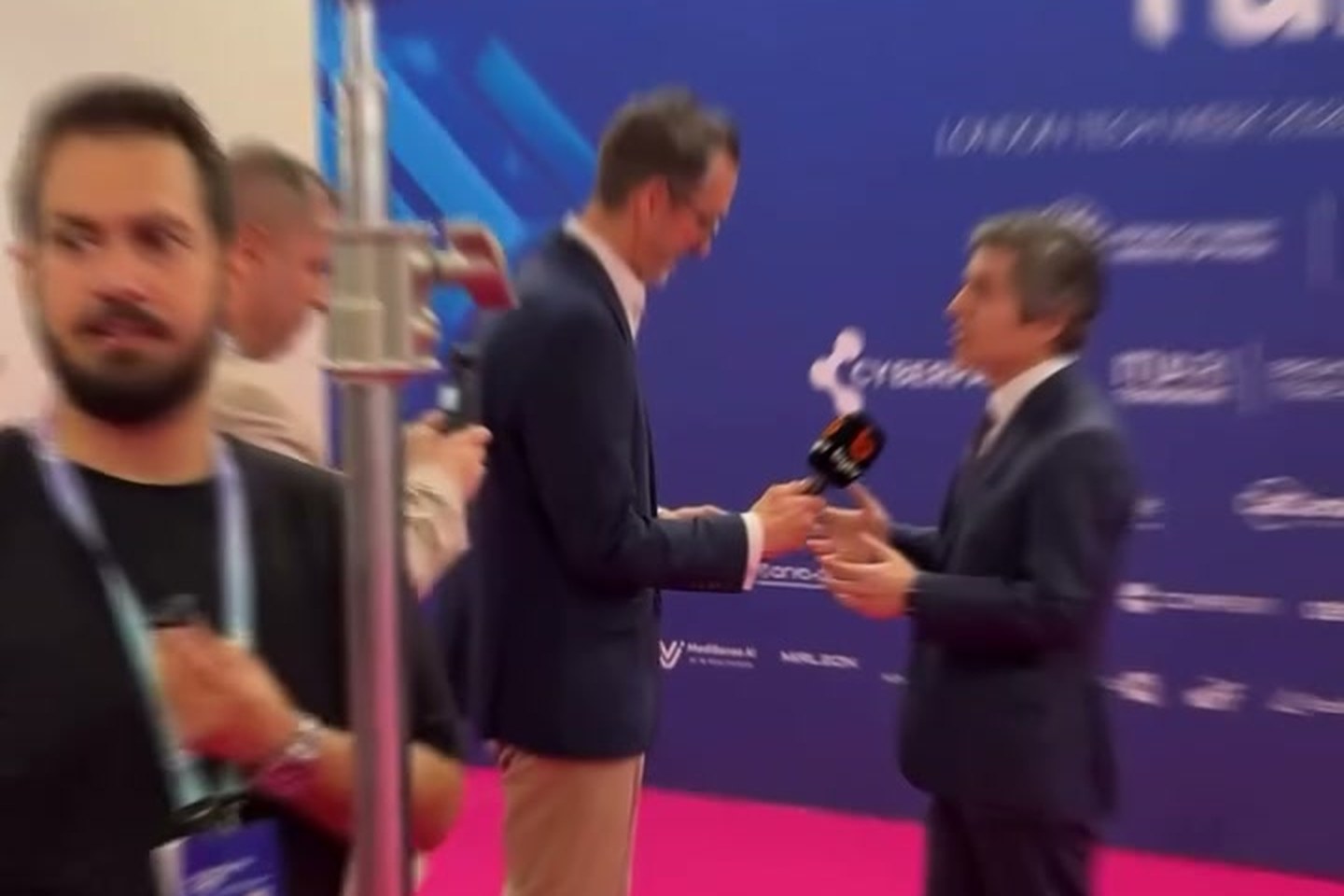 Interview being filmed with a lighting rig at a London conference stand