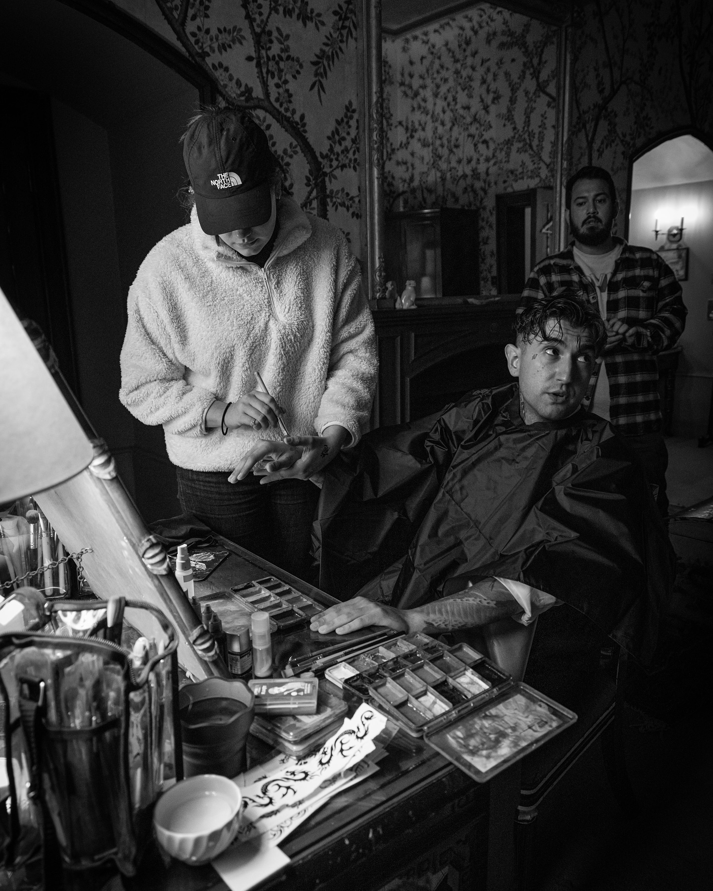 Stylist preparing an artist on set before a music video shoot